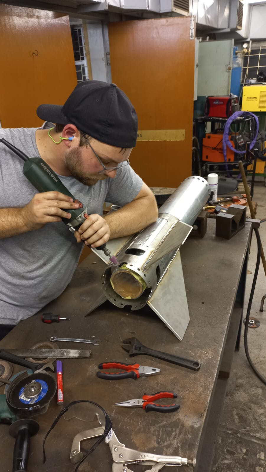 Customer machining a metal rocket airframe in a workshop
